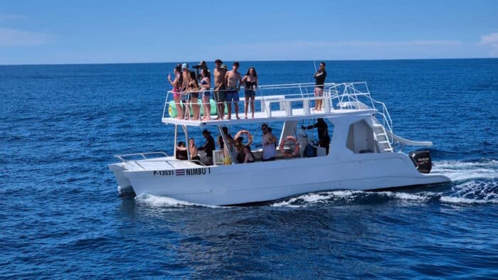 people on a boat with a slide in samara costa rica