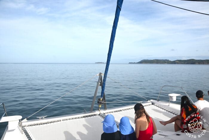 People sitting on a boat looking at ocean