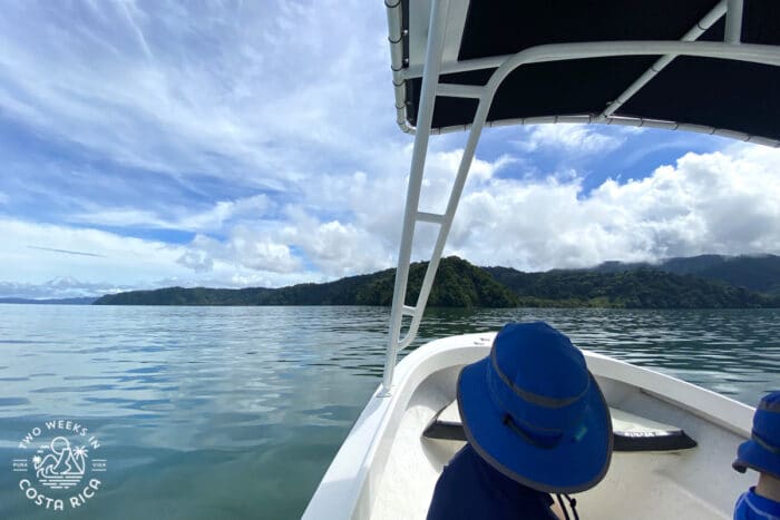 person sitting in a boat looking out at the ocean