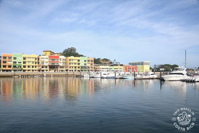 bright colored buildings next to the ocean with boats