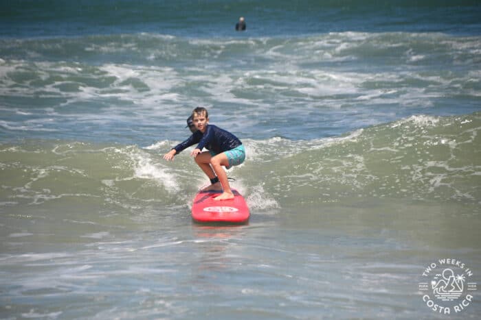 catching a wave during a surf lesson in playa nosara
