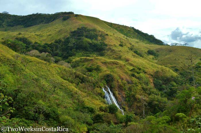 two waterfalls spilling out of the hillside in Costa Rica