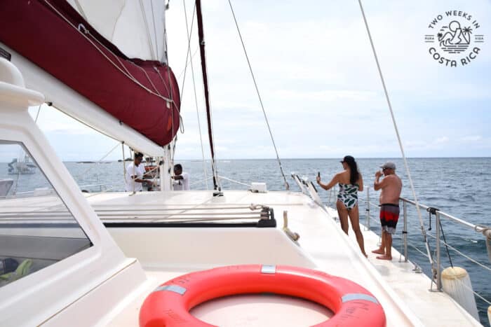 two people on a boat with an orange lifesaver in the foreground