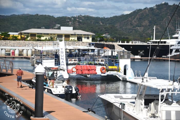 large catamaran boat with slide at a marina