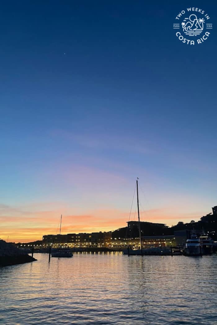 view of buildings from the water with sunset