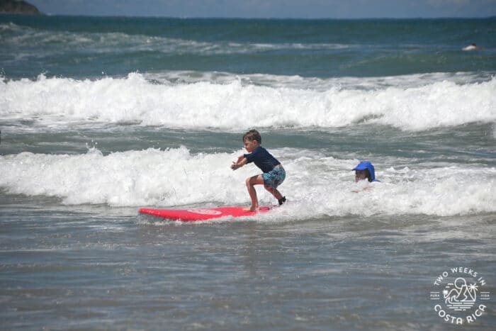 young child taking a surf lesson in nosara costa rica