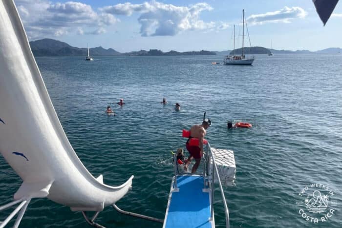 boat with a waterslide going into the ocean
