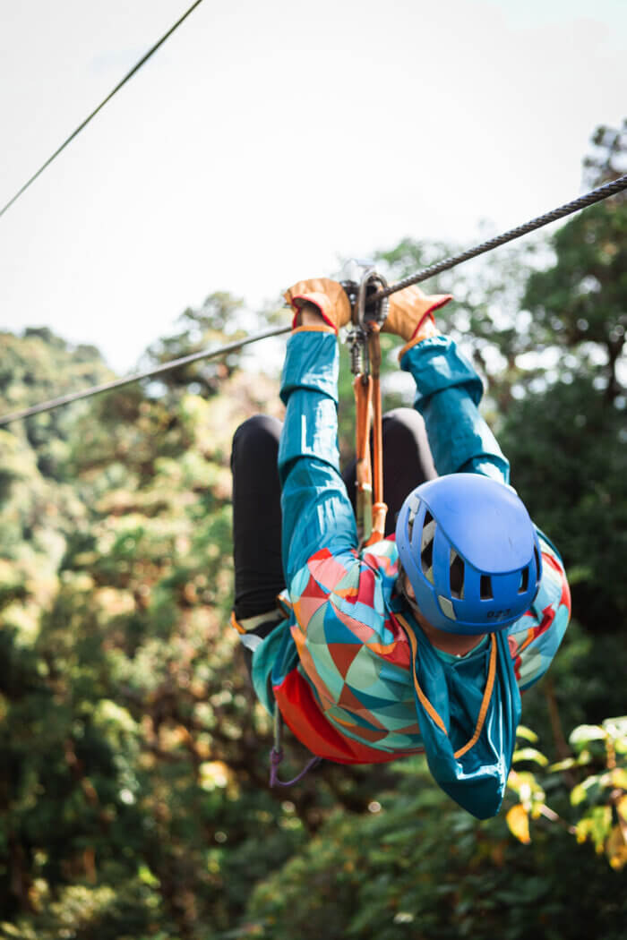 person holding a zipline pulley